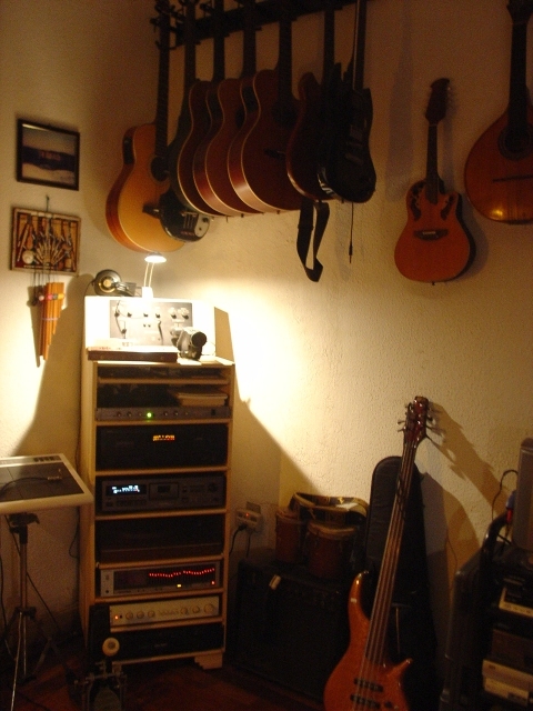 The SPD20 and the audio rack with post production hardware. Guitars and basses ranging from the wall